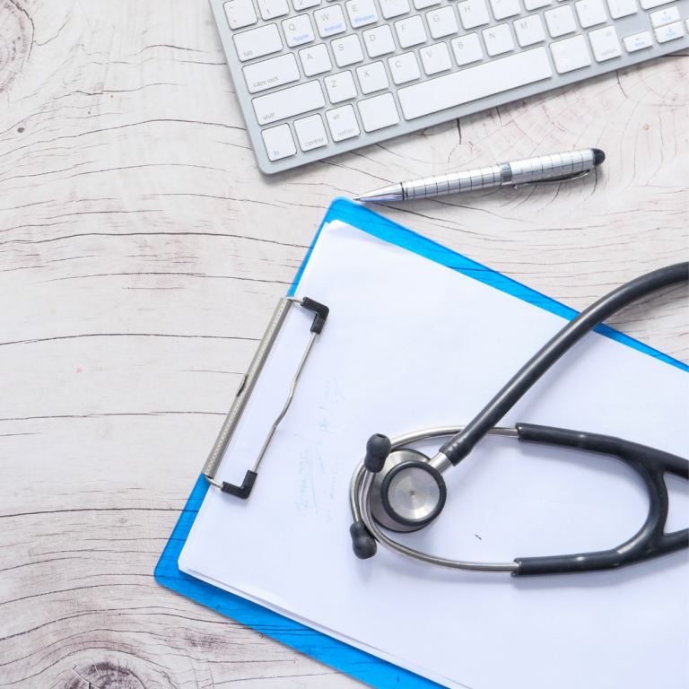 image of a doctors desk with a keyboard, pen, chart and stethoscope on it. The image represents Patient Guards Medical Device and IVD regulatory and Quality Assurance Services.