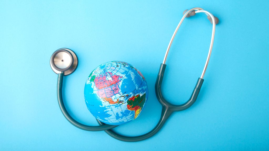 Picture of a globe with a stethoscope around it, the background is light blue - The image is used to represent patient guards medical device services.