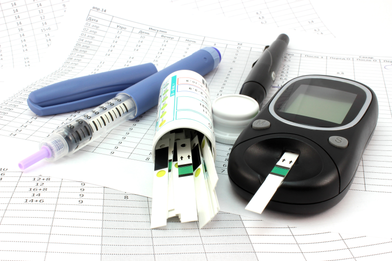 Photograph of medical devices including blood glucose meters, injector pens and IVD test strips
